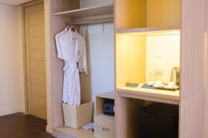 a closet with a robe hanging in a room at The Muse Hotel in Boracay