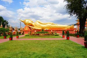 a large golden statue of a dog in a park at Memory Hotel in Vientiane