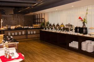 a restaurant with a counter with dishes on it at The Muse Hotel Boracay in Boracay