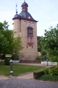 un gran edificio de ladrillo con una torre de reloj en Pension-Allendorf, en Oestrich-Winkel