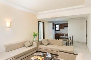 a living room with a couch and a table at Le Corail Suites Hotel in Tunis