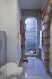 a bathroom with a walk in shower next to a room with a shower at Hotel Empress Zoe in Istanbul