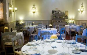 a dining room with tables and chairs with wine glasses at Palacio de Cutre in La Goleta