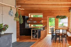 a kitchen and dining room with a table and chairs at Smart Wood House in Tamsweg