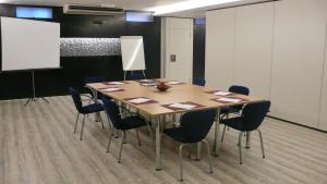 a conference room with a wooden table and chairs at La Ermita in Brunete