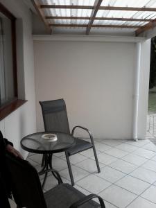 a small table and chair on a patio at Lientjies Overnight in George