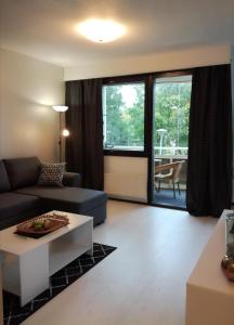 a living room with a couch and a table at A lovely one-room apartment near the city centre. in Vaasa