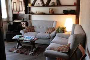 a living room with a couch and a table at Stile e Tradizione in Saint Vincent