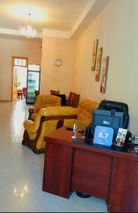 a living room with couches and a table with a cash register at Hotel Sali in Tbilisi City