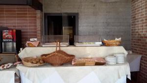 una mesa con cestas de comida y platos. en Residence Garden, en Cannobio