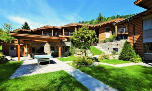 a house with a bench in the middle of a yard at Resort Tirol am Wildenbach in Niederau