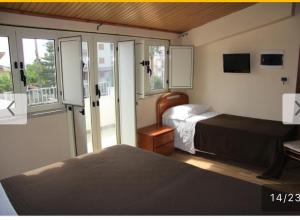 a hotel room with two beds and a balcony at B&B MeriGio' in Villapiana +18 photos
