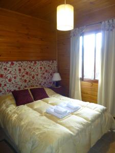 Postel nebo postele na pokoji v ubytování Hosteria Rukahué