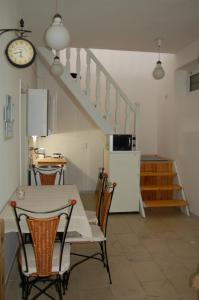 a kitchen with a table and chairs and a staircase at Apartman Rosé in Eger