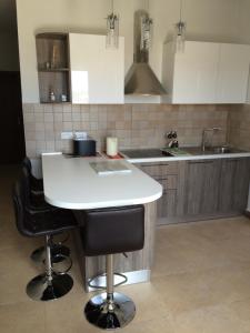 a kitchen with a white counter top and a sink at SEAVIEW Marsascala Apartment in Marsaskala