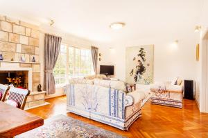 a living room with two couches and a fireplace at Villa Pavlović in Herceg-Novi