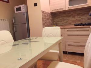 a kitchen with a table with chairs and a refrigerator at Szent János Vendégház in Eger +15 photos