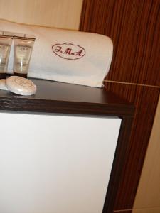 a table with a towel and two glasses on it at Apartamenty I.M.A. in Poznań