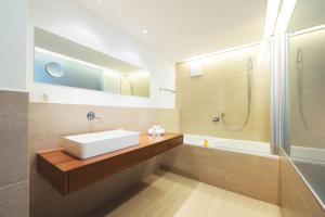 a bathroom with a sink and a shower at Skihotel Galzig in Sankt Anton am Arlberg