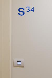 a door with a clock on the side of it at Hotel Mediterraneo in Sottomarina