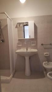 a bathroom with a sink and a shower and a toilet at Borgo Saraceno in Sambuca di Sicilia