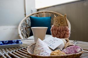 a basket of food on a table with an owl toy at Le Tre Civette in Sassari