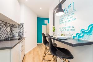 a kitchen with a dining table and two chairs at Flumen in Rijeka