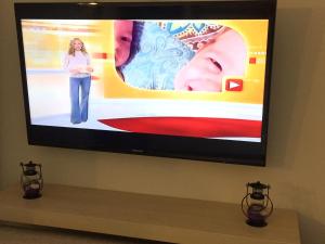a flat screen tv hanging on a wall at Hotel Alexandros II in Toroni