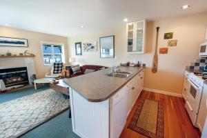 a kitchen with a sink and a living room at Waterfront Condo by OnlyBC 202 in Tofino