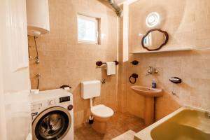 a bathroom with a washing machine and a sink at Villa Pavlović in Herceg-Novi +45 photos