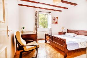 a bedroom with a bed and a desk and a chair at Villa Pavlović in Herceg-Novi
