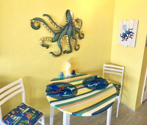 a dining room with a table with an octopus on the wall at Casa Del Mar - Ocean View in Galveston