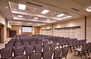 a conference room with chairs and a screen in it at Hyatt Place Salt Lake City/Lehi in Lehi