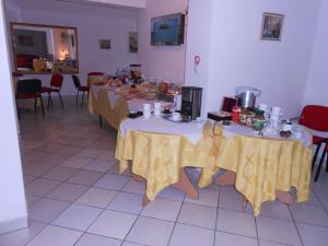 a room with two tables with yellow table cloth at Hotel As in Biała Podlaska