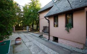 a small house with a driveway next to a building at Malomtavi Vendégház in Tapolca