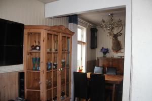 a dining room with a table and a chandelier at Bergen Sentrum Apartment in Bergen