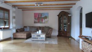 a living room with a couch and a table at Ferienwohnung Haffner in Kandern