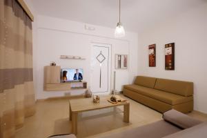 a living room with a couch and a table at Petra Thea Apartments 2 in Kalamata