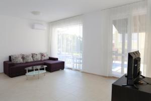 A television and/or entertainment centre at St. Stefan Villas & Hotel