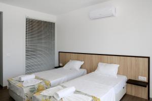 A bed or beds in a room at St. Stefan Villas & Hotel