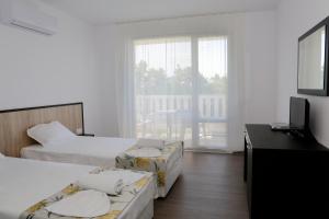 A bed or beds in a room at St. Stefan Villas & Hotel