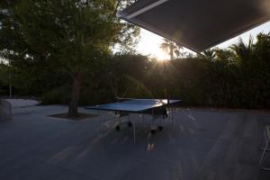 a ping pong table with the sun in the background at Bed & Breakfast del Faro in Giovinazzo