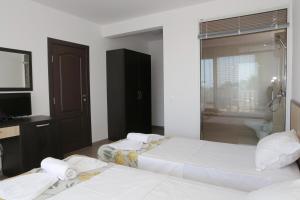 A bed or beds in a room at St. Stefan Villas & Hotel