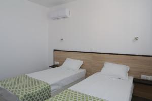 A bed or beds in a room at St. Stefan Villas & Hotel