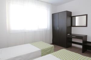 A bed or beds in a room at St. Stefan Villas & Hotel