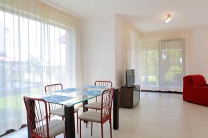 a dining room with a table and chairs and a tv at Saint Stefan Villas in Sozopol