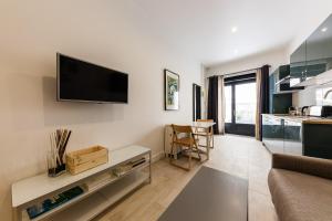 a living room with a flat screen tv on the wall at Chez Nous - 7 Appartements sur le Vieux Port in Marseille