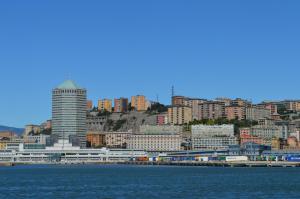 a view of a city from the water at La Lanterna Apartment in Genoa