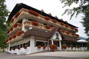 a building with flowers on the side of it at Rauzi Hotel Garnì & apartments in Malè