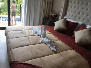 a bedroom with a bed with a white quilt at Venetian Signature PoolAccess Resort Jomtian Pattaya in Jomtien Beach